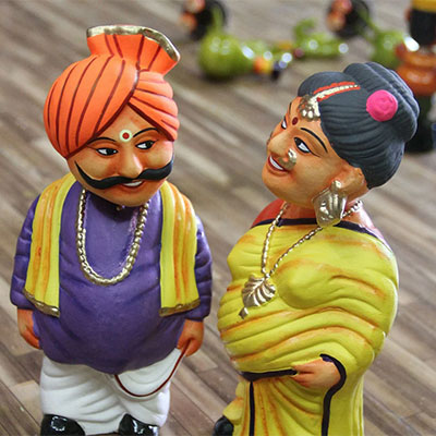 Clay art in the couple are made with the india traditional clothes